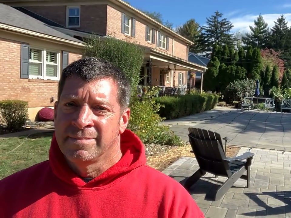 Brian DeLong, owner of Professional Landscaping Service, on a finished paver patio