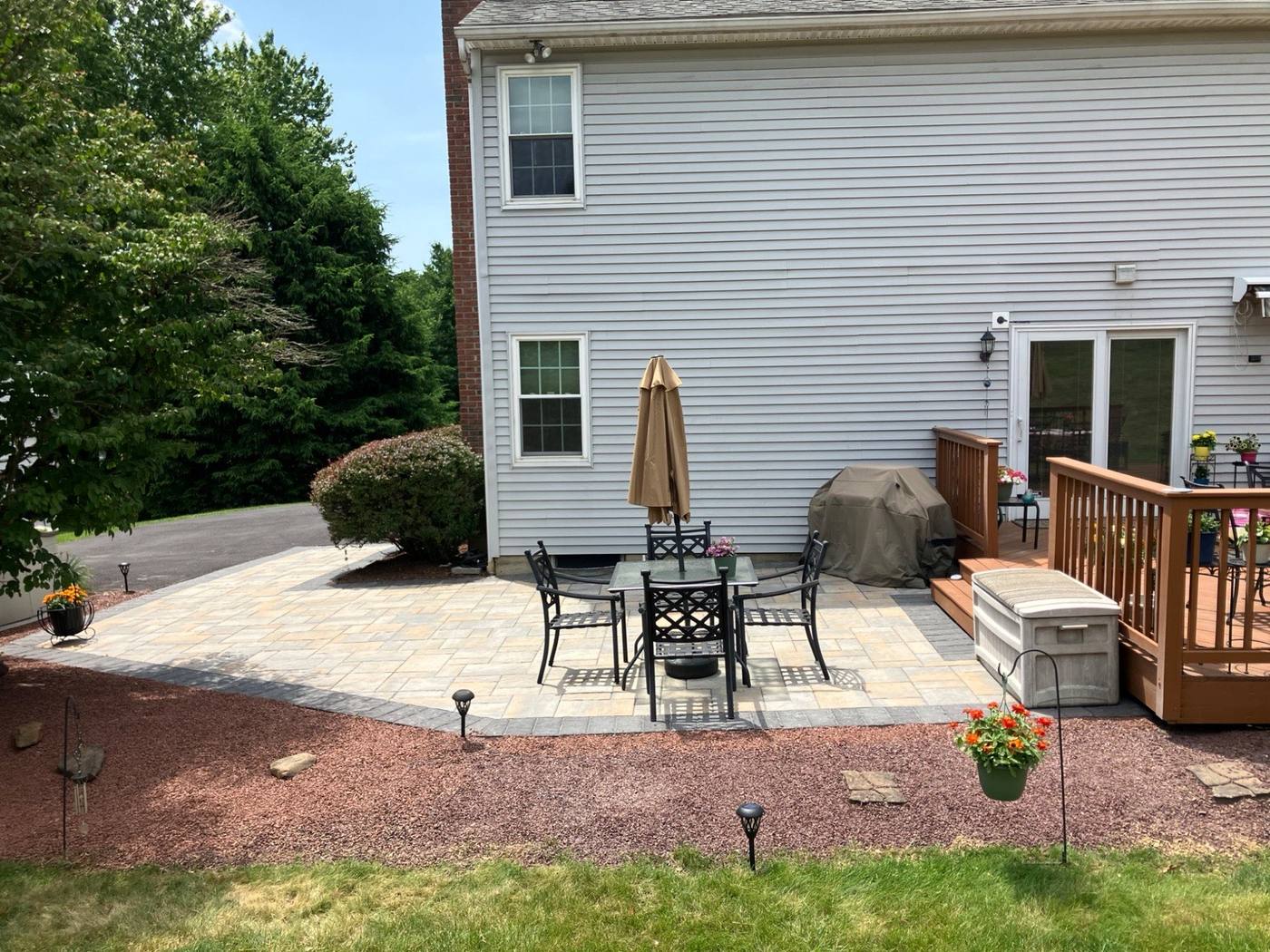 Paver patio tied into an existing deck